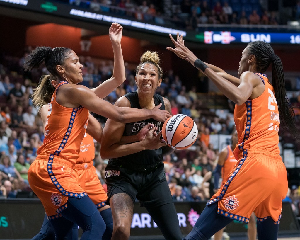 Mercedes Russell tries to muscle a shot up in between the active defensive hands of Alyssa Thomas and Dewanna Bonner.