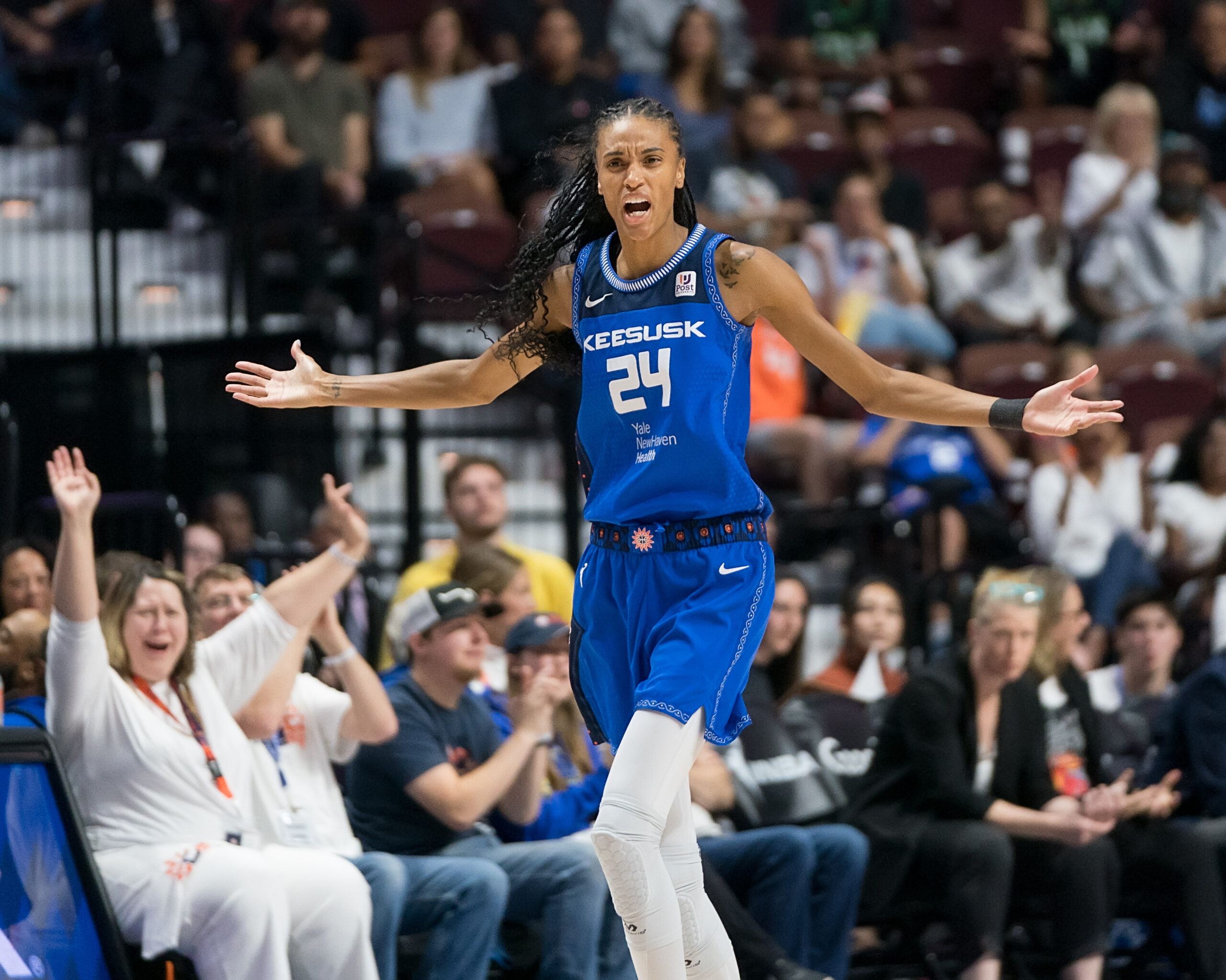 Connecticut Sun forward/guard DeWanna Bonner holds her arms out to the side, palms facing up, as she reacts to what just happened on the court.