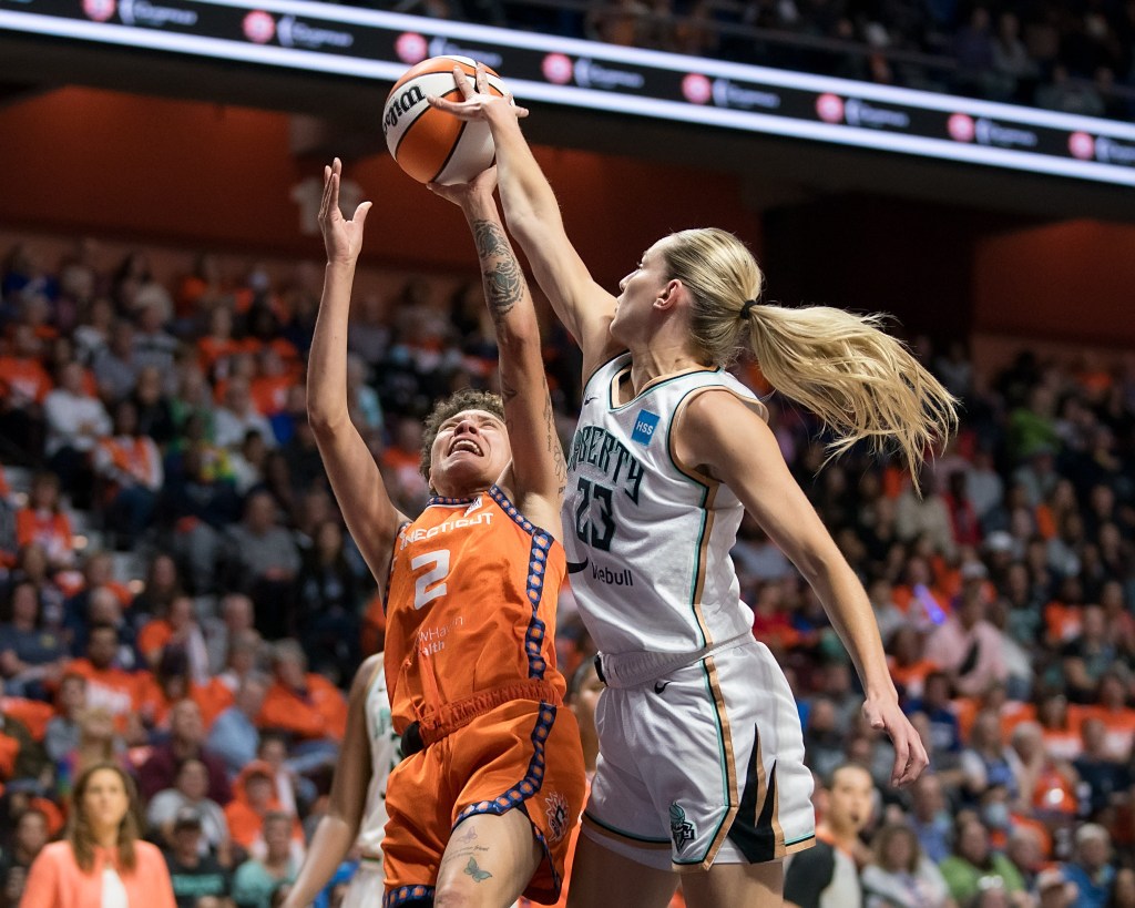 Marine Johannès uses her right arm to block Natisha Hiedeman's shot. 