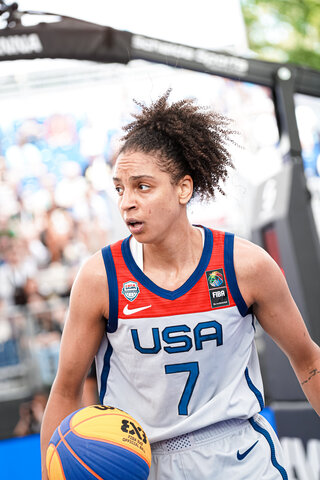 Cierra Burdick is shown in a white USA No. 7 jersey with blue trim and writing.