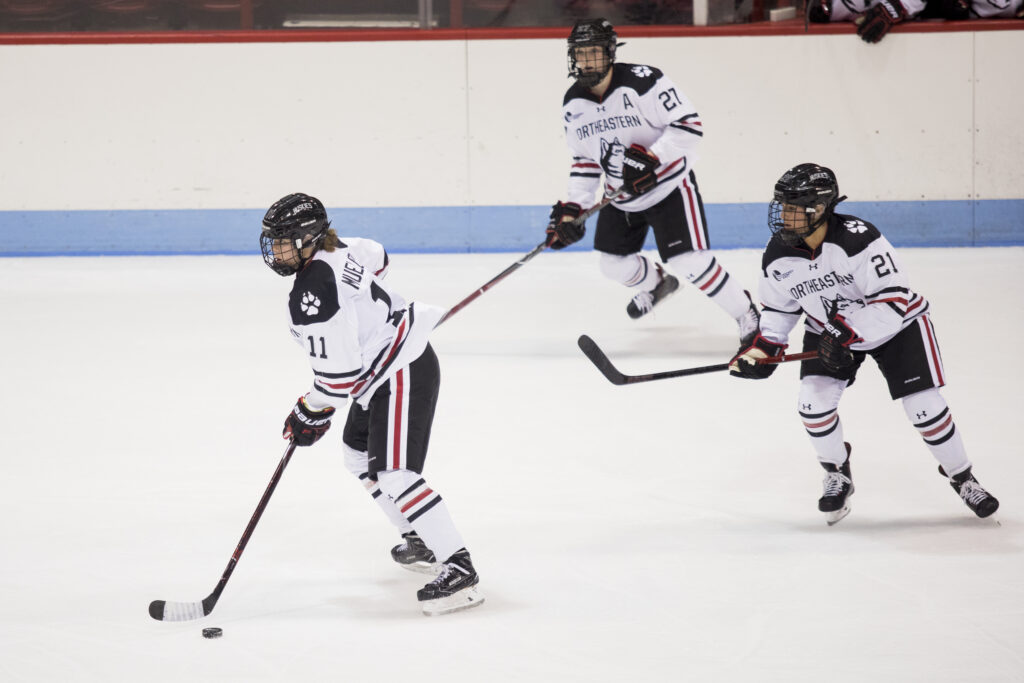 Northeastern forwards Alina Müller and Chloe Aurard during an NCAA game at Matthews Arena in Boston, MA on Oct. 12, 2018. (Photo by Michelle Jay)
