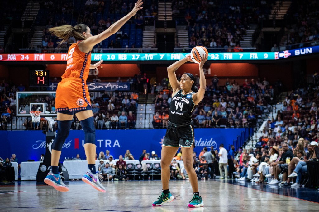 Betnijah Laney looks for a place to pass the ball around Rebecca Allen's extended arms.