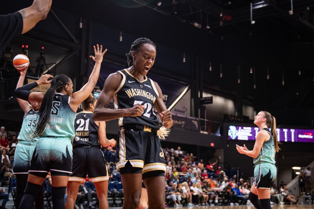 Washington Mystics guard Shatori Walker-Kimbrough yells and looks down at her clenched fists as she celebrates a play.