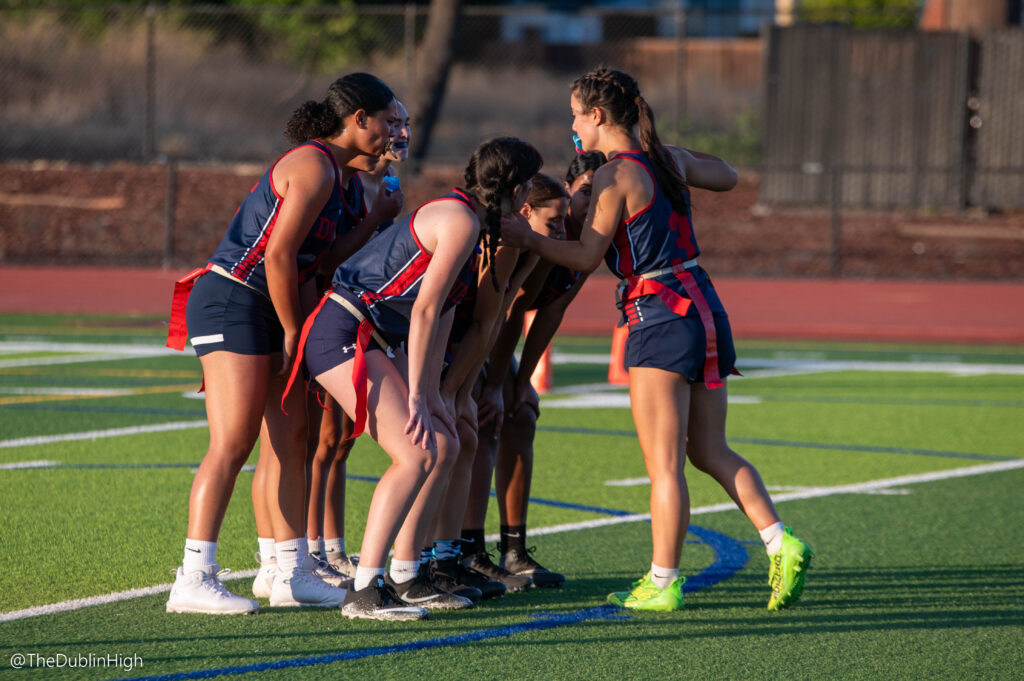 Dublin High quarterback Sydney Costello leads her team’s huddle in Tuesday’s flag football game against Foothill High School of Pleasanton. (Charles Denhert, Dublin Unified School District)