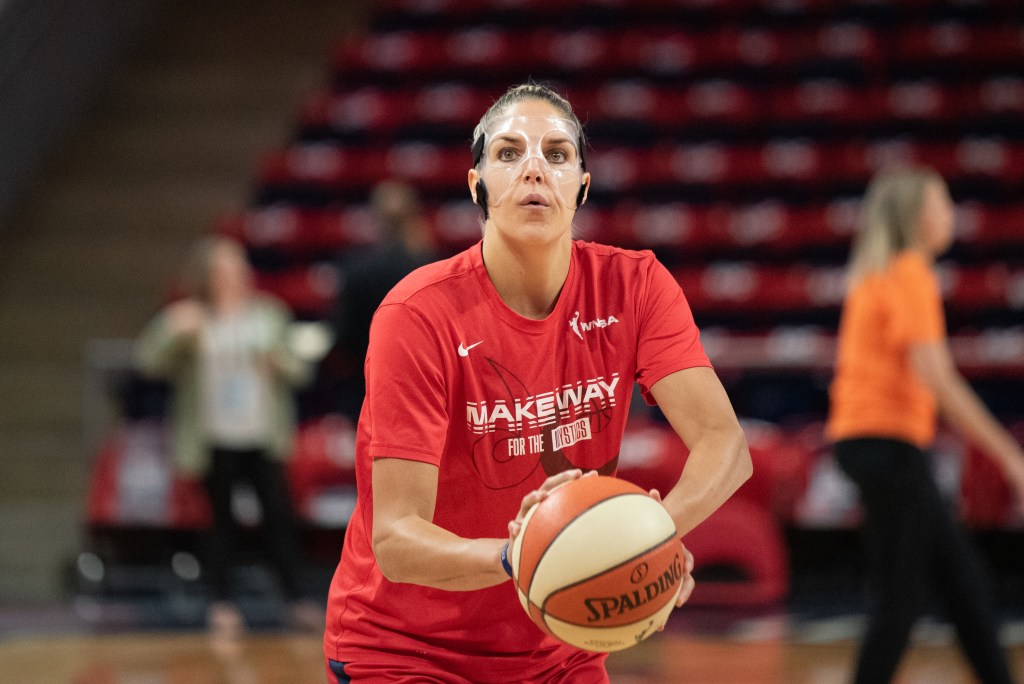 Washington Mystics forward Elena Delle Donne, wearing a clear protective face mask, prepares to shoot the ball during warmups.