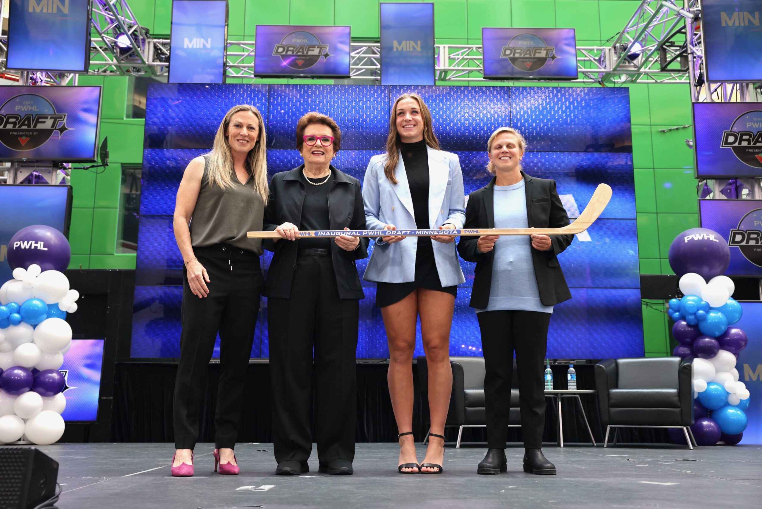 Jayna Hefford, Billy Jean Kind, Taylor Heise and Natalie Darwitz stand on stage at the PWHL draft.