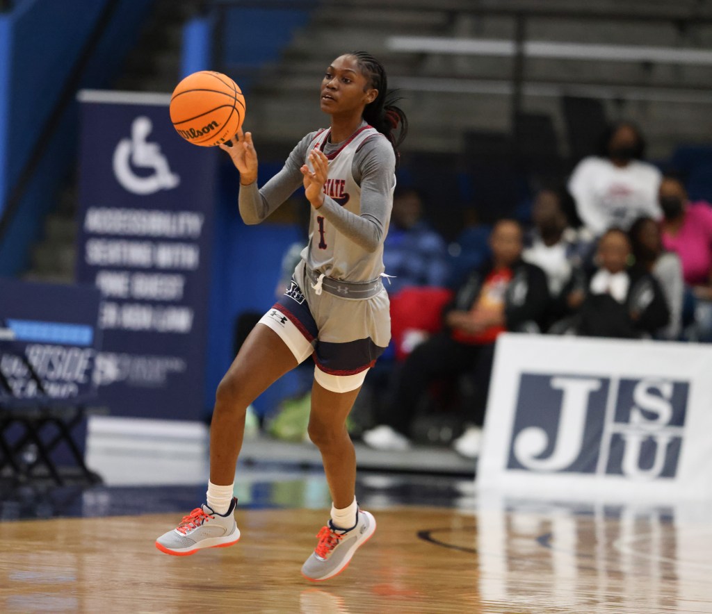 Jackson State guard Ti'lan Boler passes the ball in the open court.
