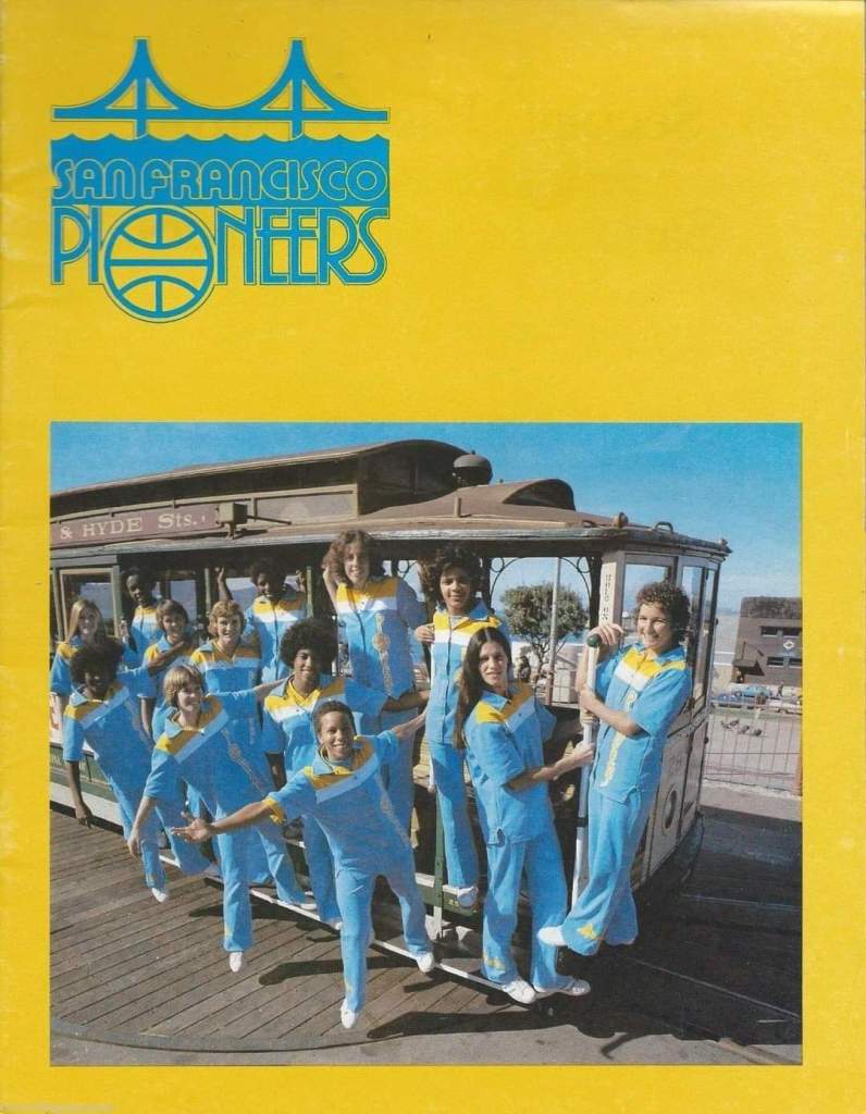 Members of the WBL's San Francisco Pioneers are pictured in their sky blue, yellow and white warm-up uniforms while posing on a city trolley.
