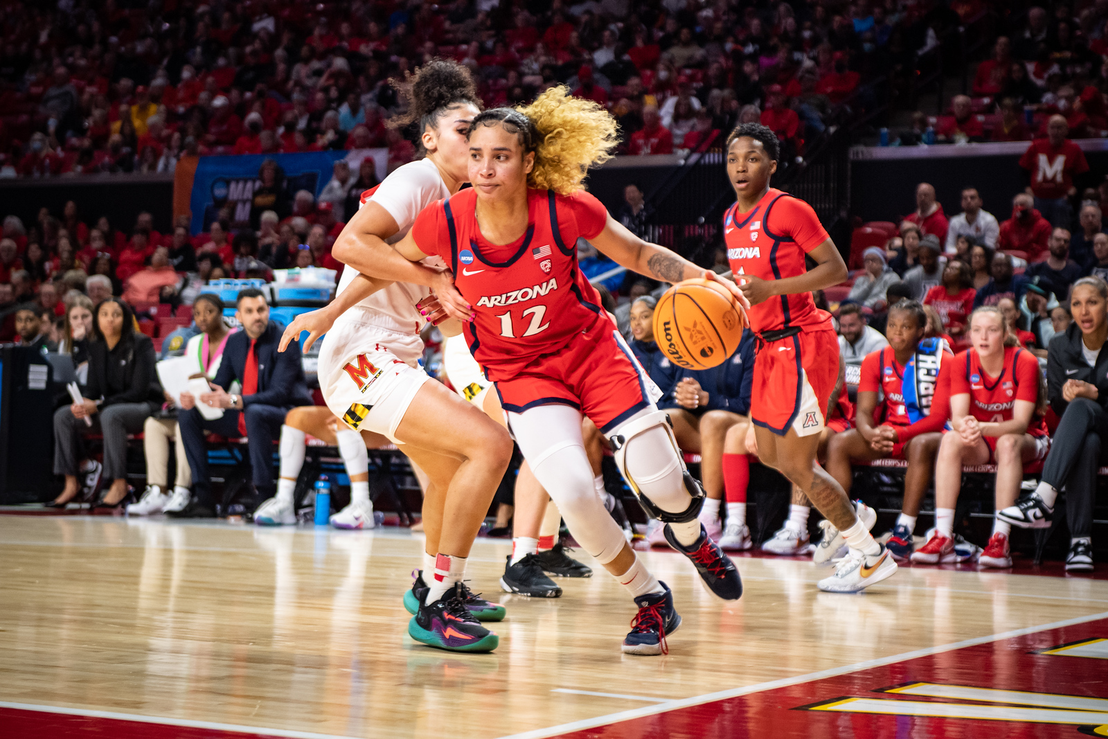 Arizona Wildcats forward Esmery Martinez drives to the basket. She is wearing a red #12 Arizona jersey.