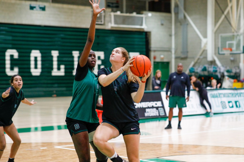 Dartmouth forward Clare Meyer attempts a post move against forward Doreen Ariik during a preseason practice.