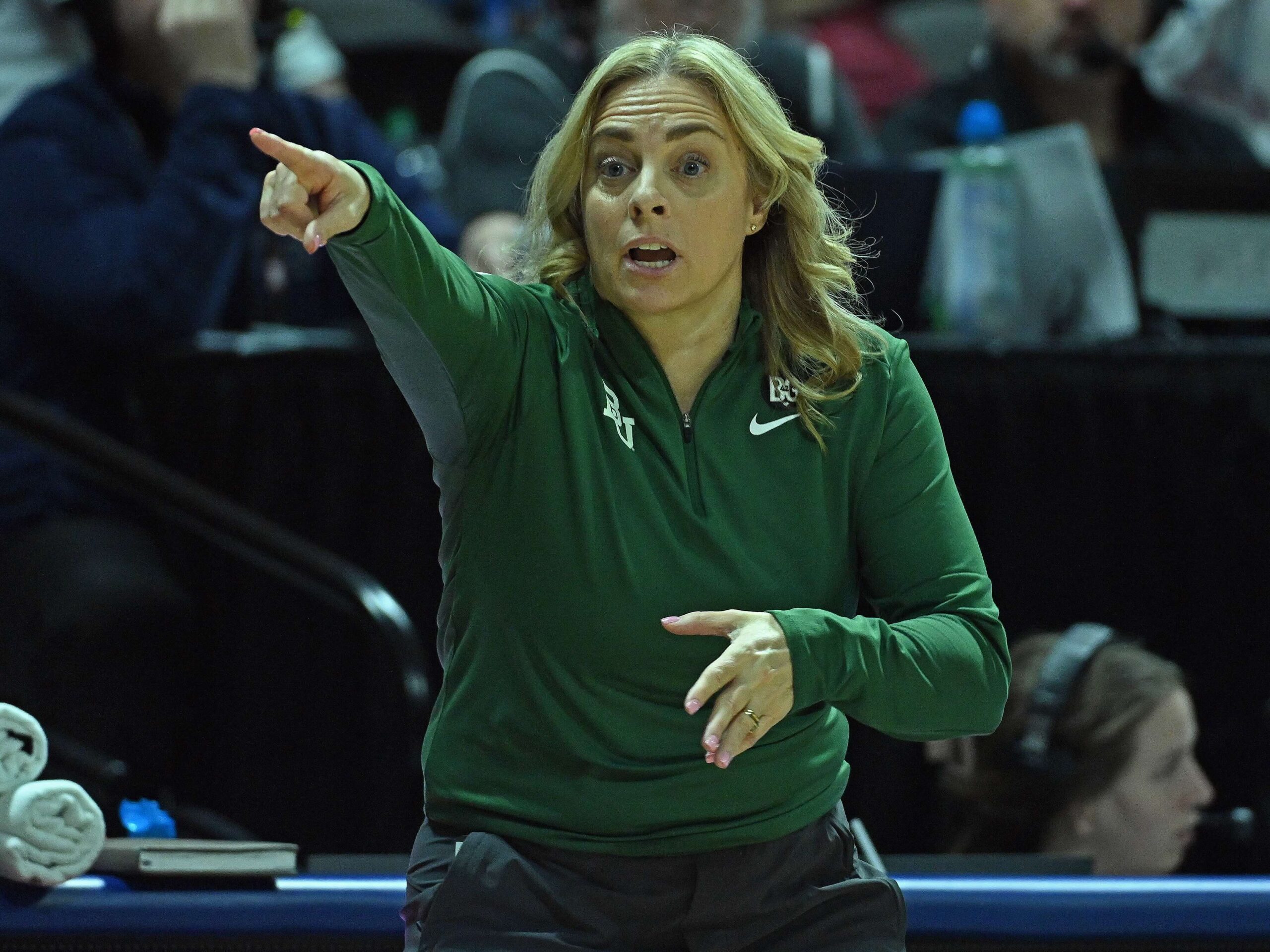 Baylor head coach Nicki Collen points toward the court from the sidelines during a game against Iowa State.
