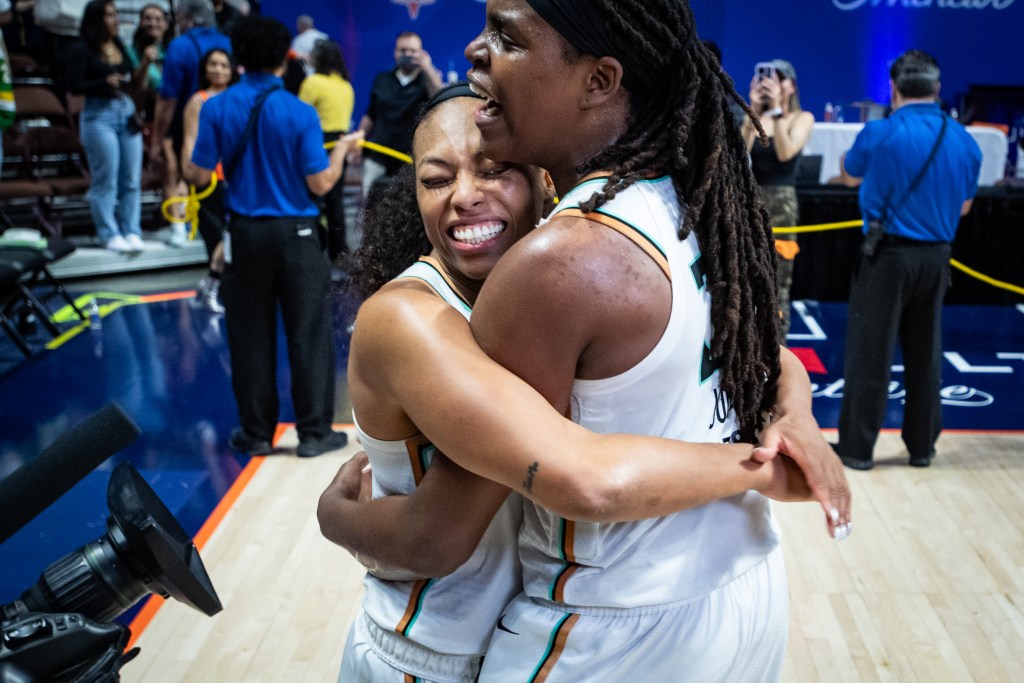 Betnijah Laney and Jonquel Jones hug each other.