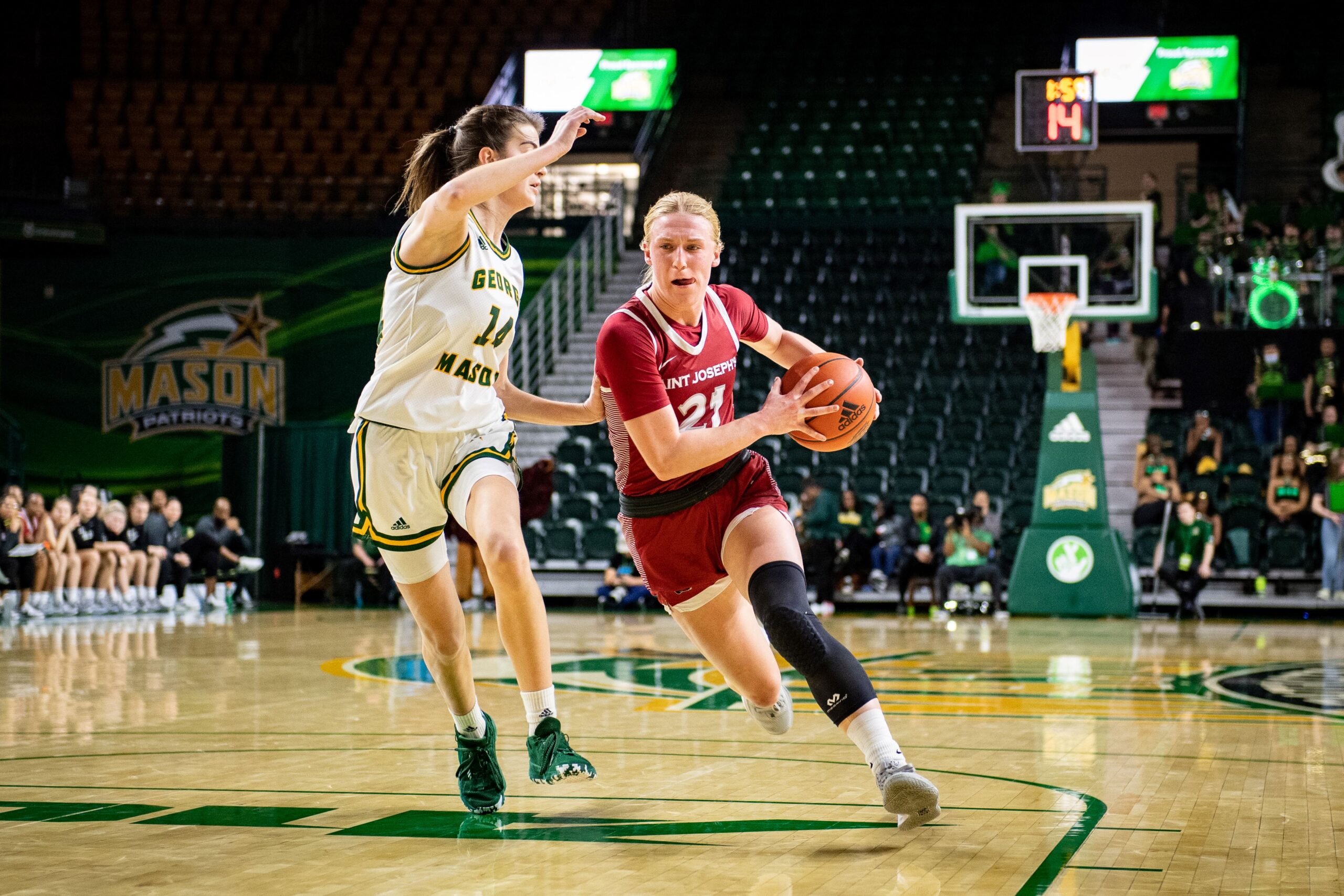 Saint Joseph's Mackenzie Smith drives to the basket against Mason's Paula Suárez