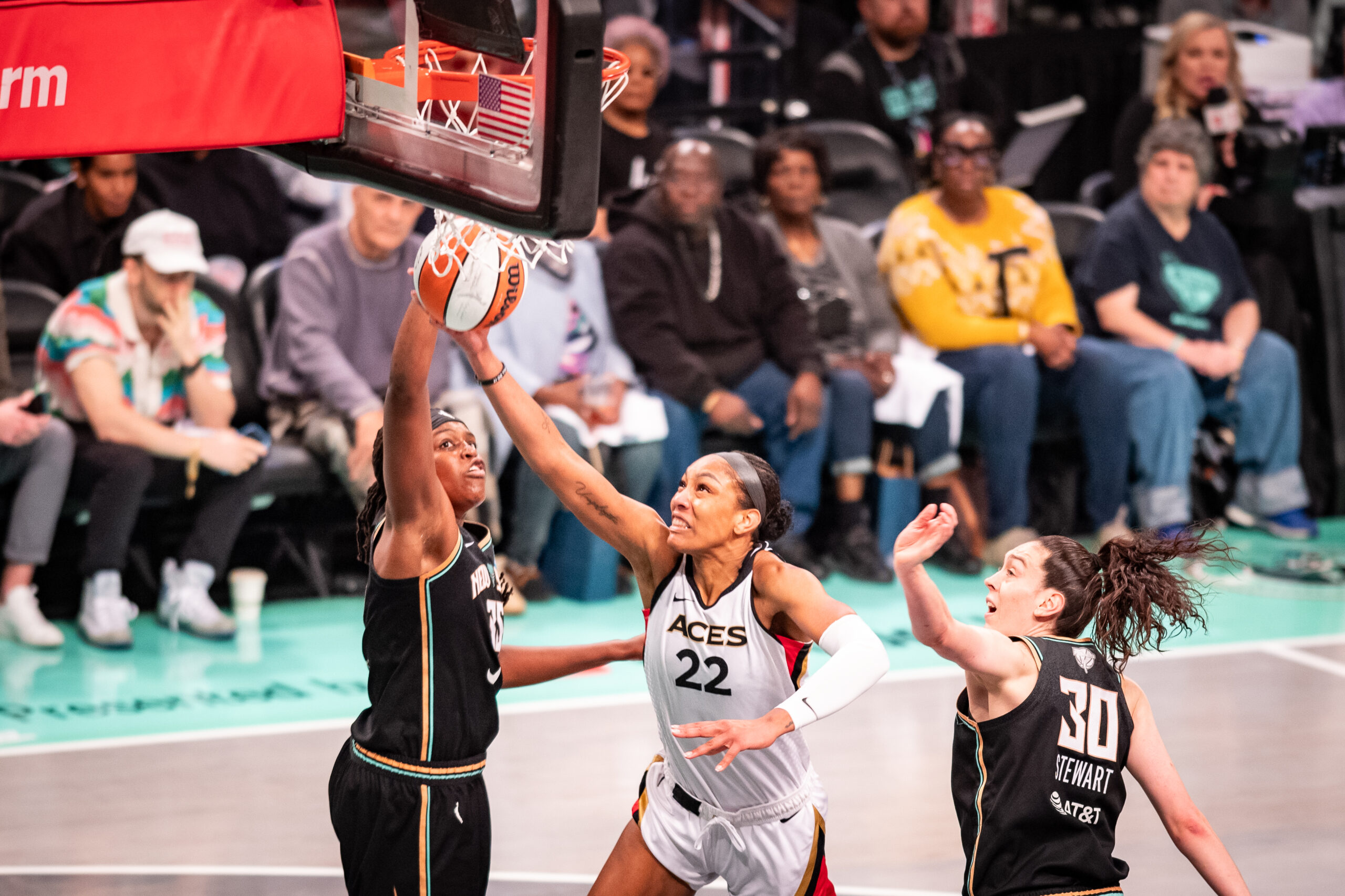 New York Liberty forwards Jonquel Jones and Breanna Stewart try to block Las Vegas Aces forward A'ja Wilson's shot.