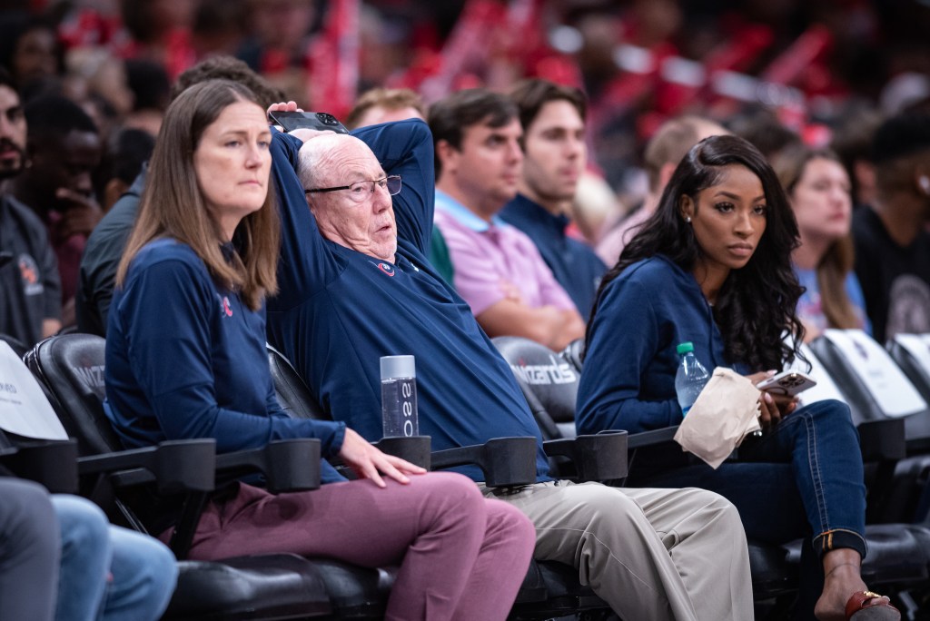Washington Mystics general manager Mike Thibault and assistant general manager Maria Giovannetti sit courtside for a game. Thibault has his arms folded behind his head, and neither executive looks too pleased with what they're watching.