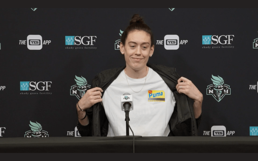 Breanna Stewart shows off her metro card inspired Puma shirt. 