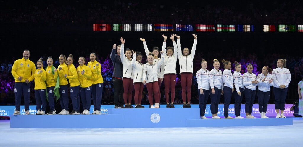 Photo of the USA gymnastics team atop the podium at Worlds.