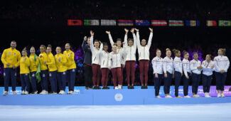 Photo of the USA gymnastics team atop the podium at Worlds.