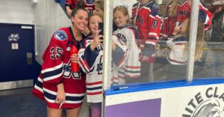 Kalamazoo Wings goalie Mariah Fujimagari poses for a selfie with fans following Saturday night's game against the Toledo Walleye. Fujimagari made 14 saves for the ECHL's first-ever win by a female goaltender. (Photo via Kalamazoo Wings/X, formerly Twitter)