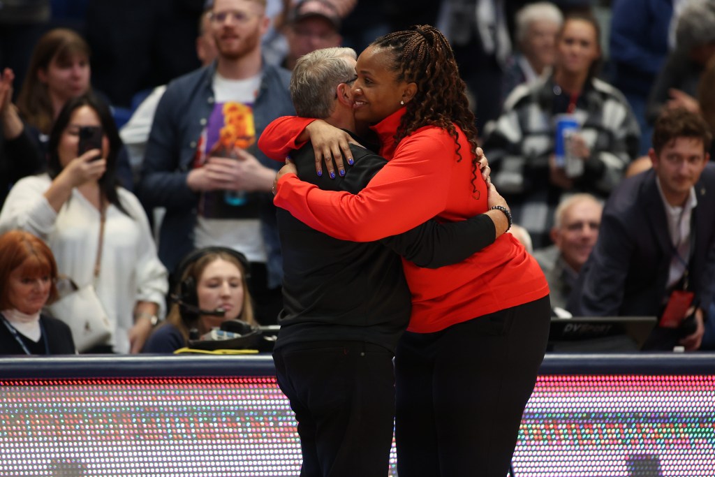 Dayton head coach Tamika Williams-Jeter embraces UConn head coach Geno Auriemma as the crowd looks on after the Huskies' 102-58 win over the Flyers on Nov. 8, 2023 matchup against UConn at the XL Center in Hartford, CT. Williams-Jeter played for the Huskies from 1998-2002.