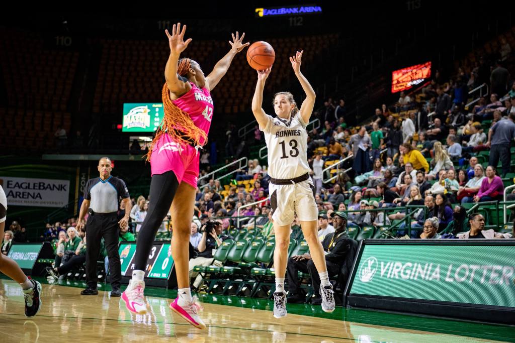 St. Bonaventure's Maddie Dziezgowski shoots a 3-pointer while Mason's Nalani Kaysia defends the shot