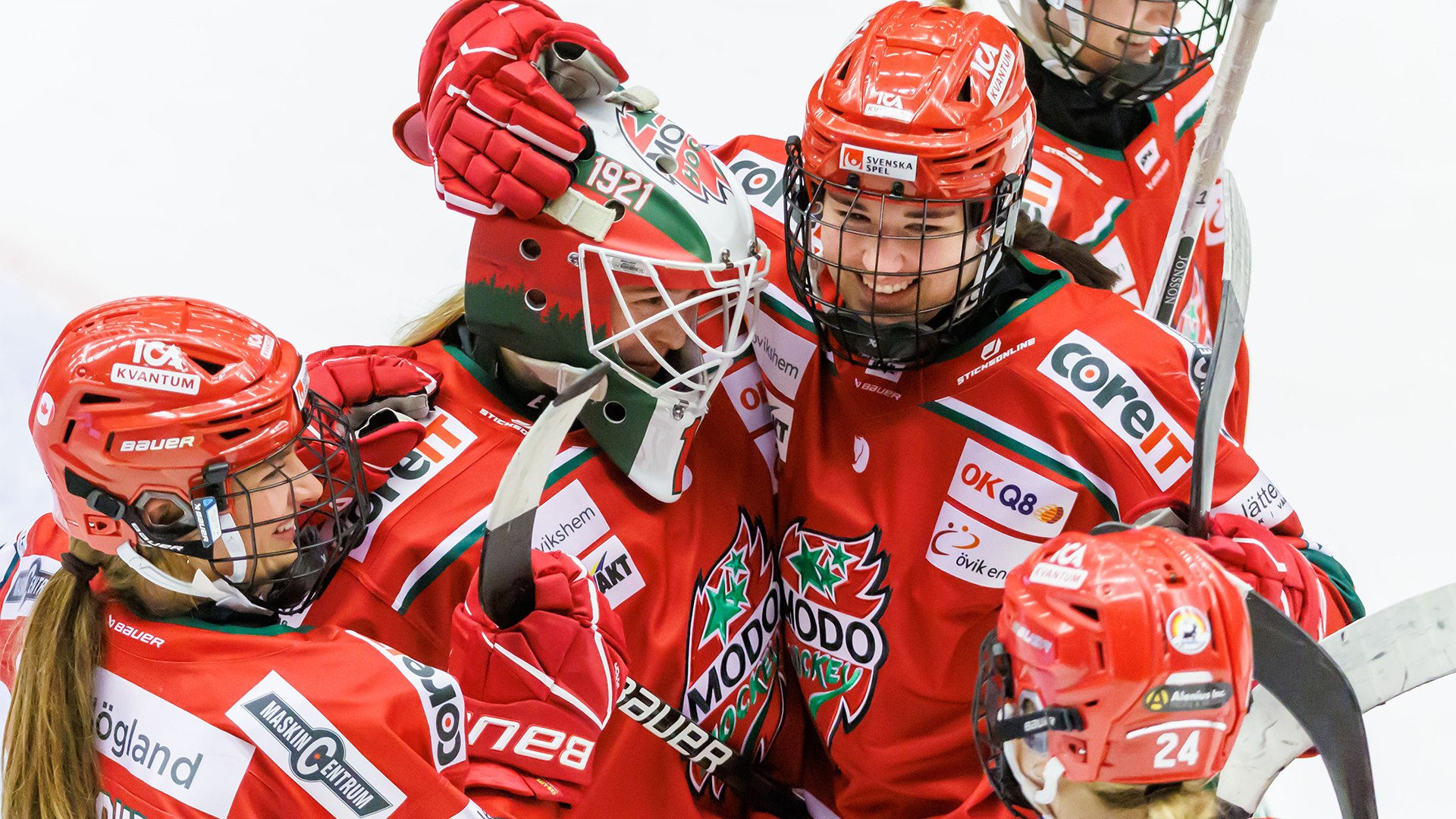 Taylor House is pictured celebrating on the ice alongside SDHL teammates. They are wearing the team's red and white uniforms.