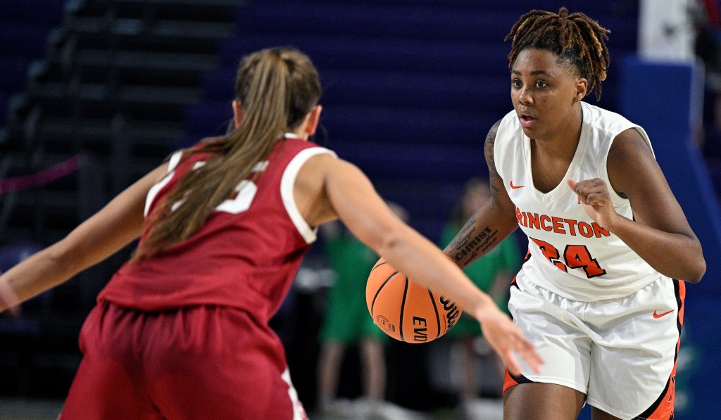 Princeton guard Mari Bickley dribbles the ball with her right hand and holds her left hand up in a fist.