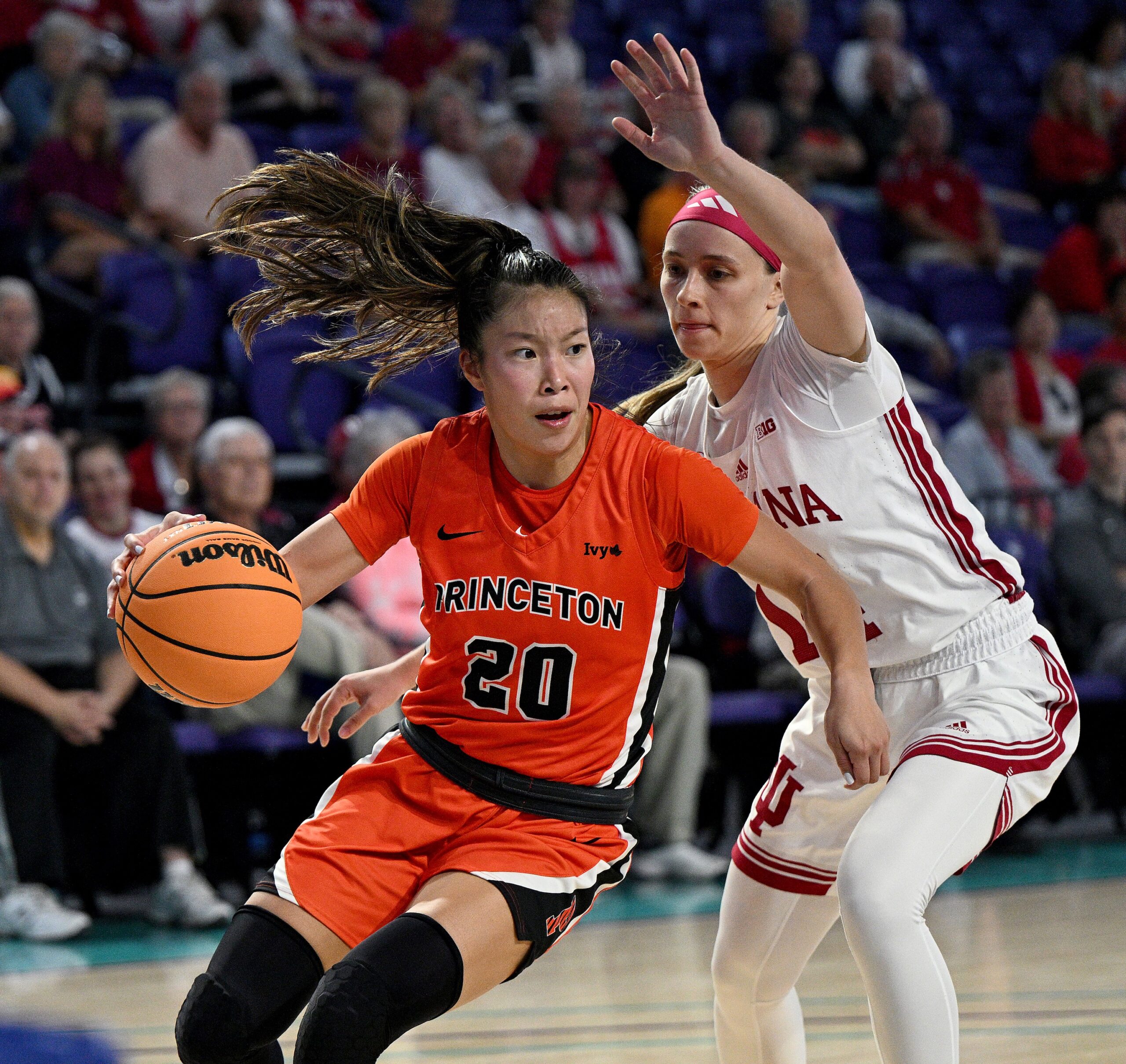 Princeton guard Kaitlyn Chen dribbles the ball with her right hand and turns the corner against Indiana guard Sara Scalia.
