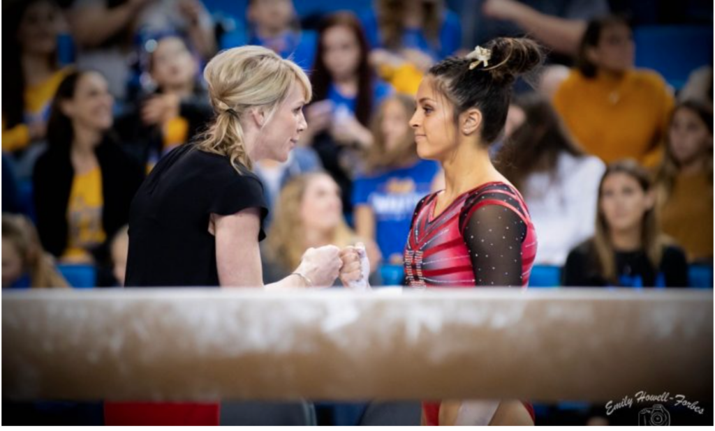 Carly Dockendorf on the job at Utah. Photo credit: College Gym News