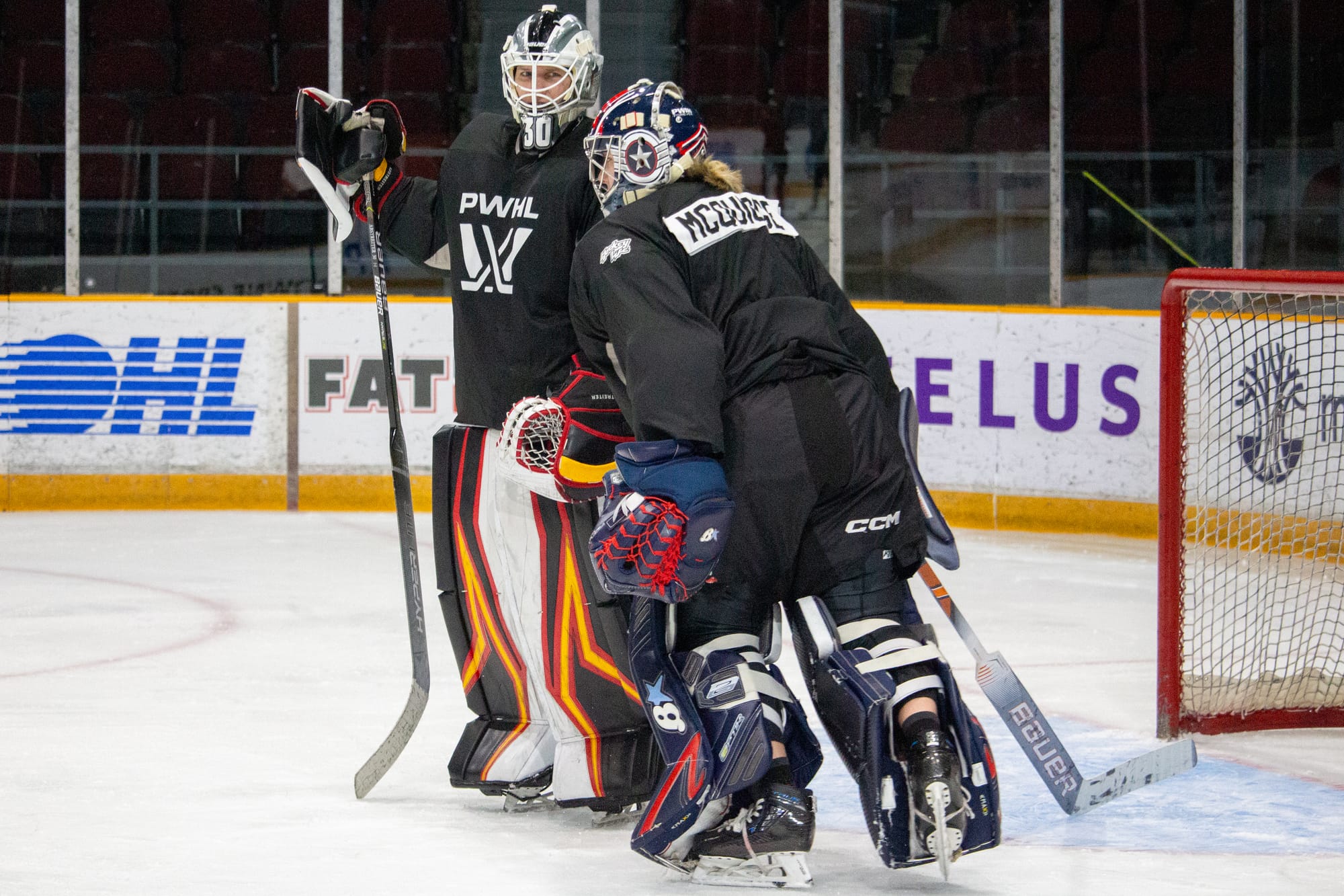 Goalies Sandra Abstreiter and Rachel McQuigge talk during a practice