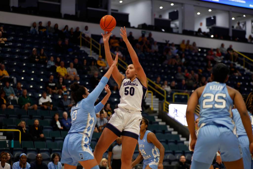 Kansas State center Ayoka Lee shoots a fadeaway jump shot over a UNC defender putting a hand in Lee's face.