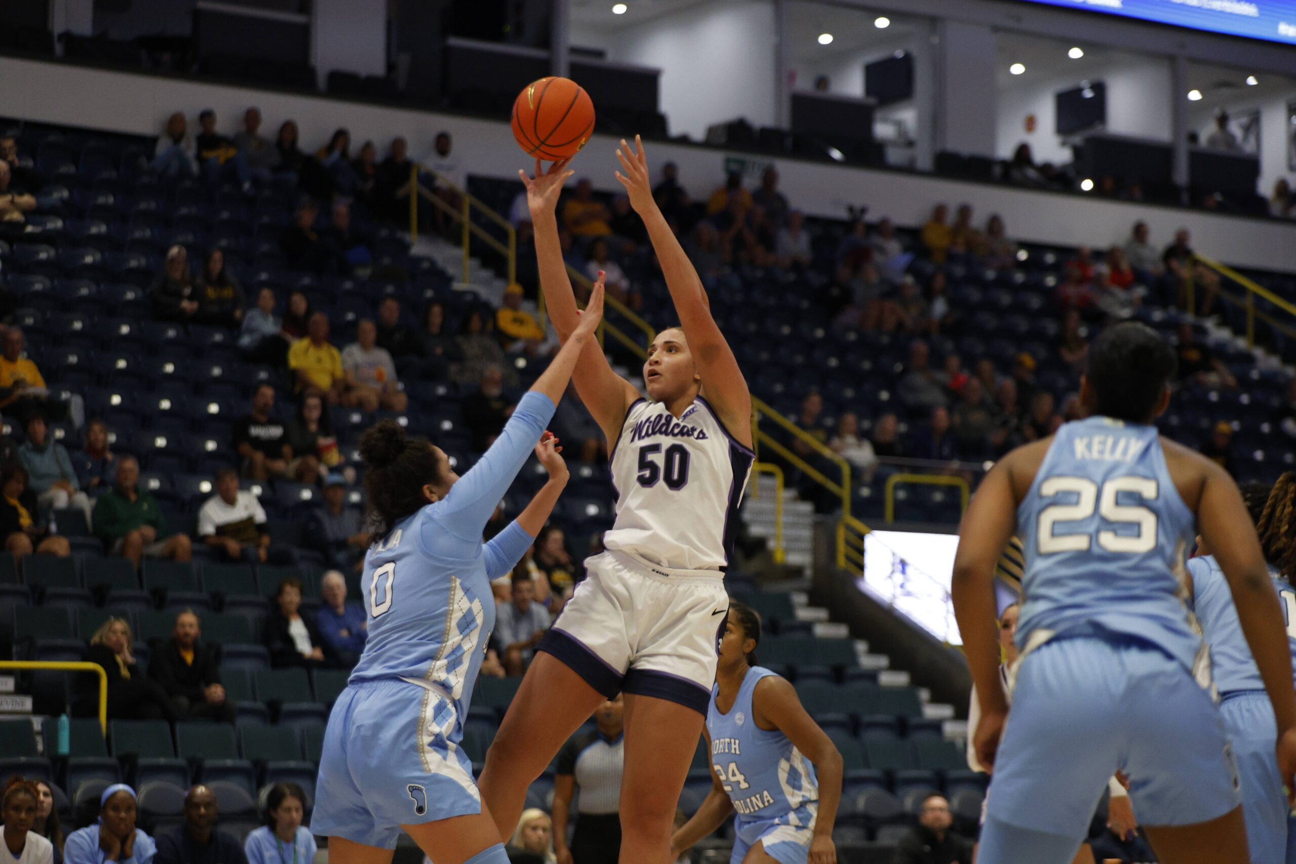 Kansas State center Ayoka Lee shoots a fadeaway jump shot over a UNC defender, who has a hand in Lee's face.