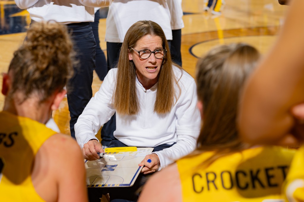 Michigan head coach Kim Barnes Arico talks to her team during a timeout against Oakland on Nov. 14.