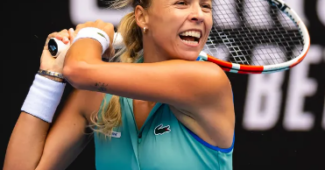 Anett Kontaveit of Estonia smiles on the court with her racket over her shoulder.
