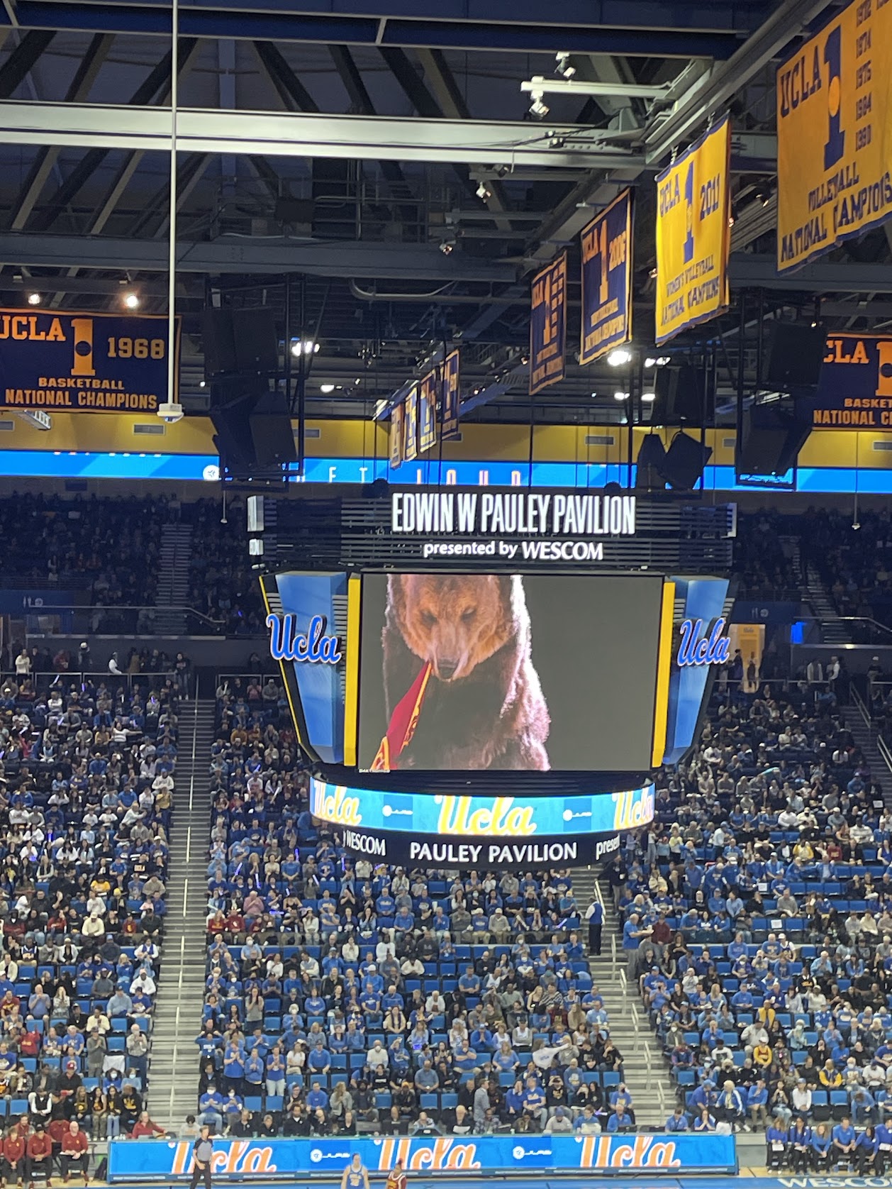 UCLA's jumbotron features a bear destroying a USC jersey ahead of the rivalry matchup on December 30, 2023.