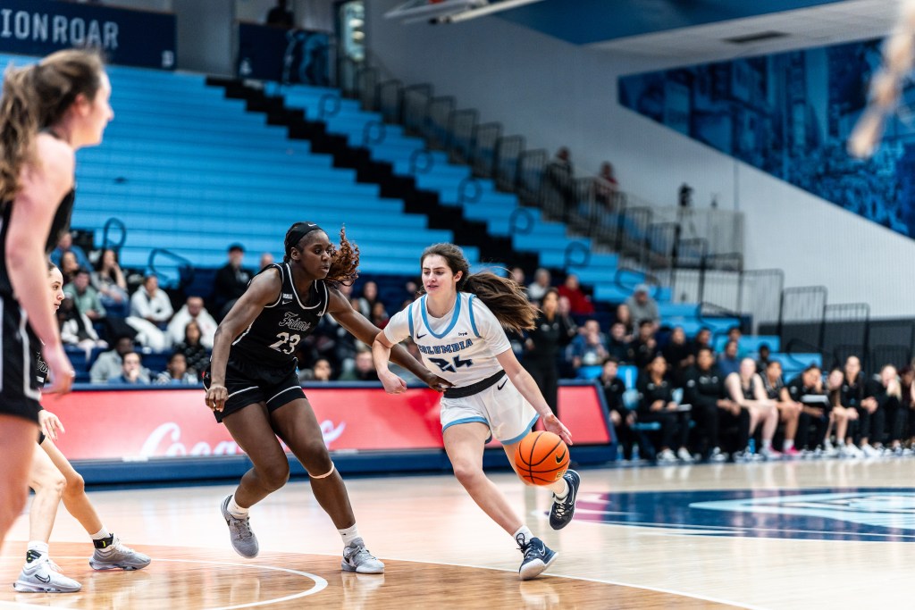 Columbia guard Riley Weiss drives with her left hand from near the top of the key as a Providence defender attempts to contain her.