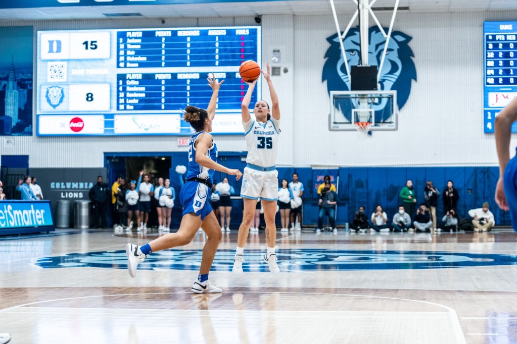 Columbia guard Abbey Hsu shoots a jump shot from the top of the key as a Duke defender tries to get a hand up.