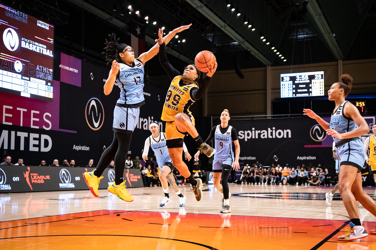 Odyssey Sims goes up for a layup against defender Allisha Gray in the 2023 AU Hoops season.