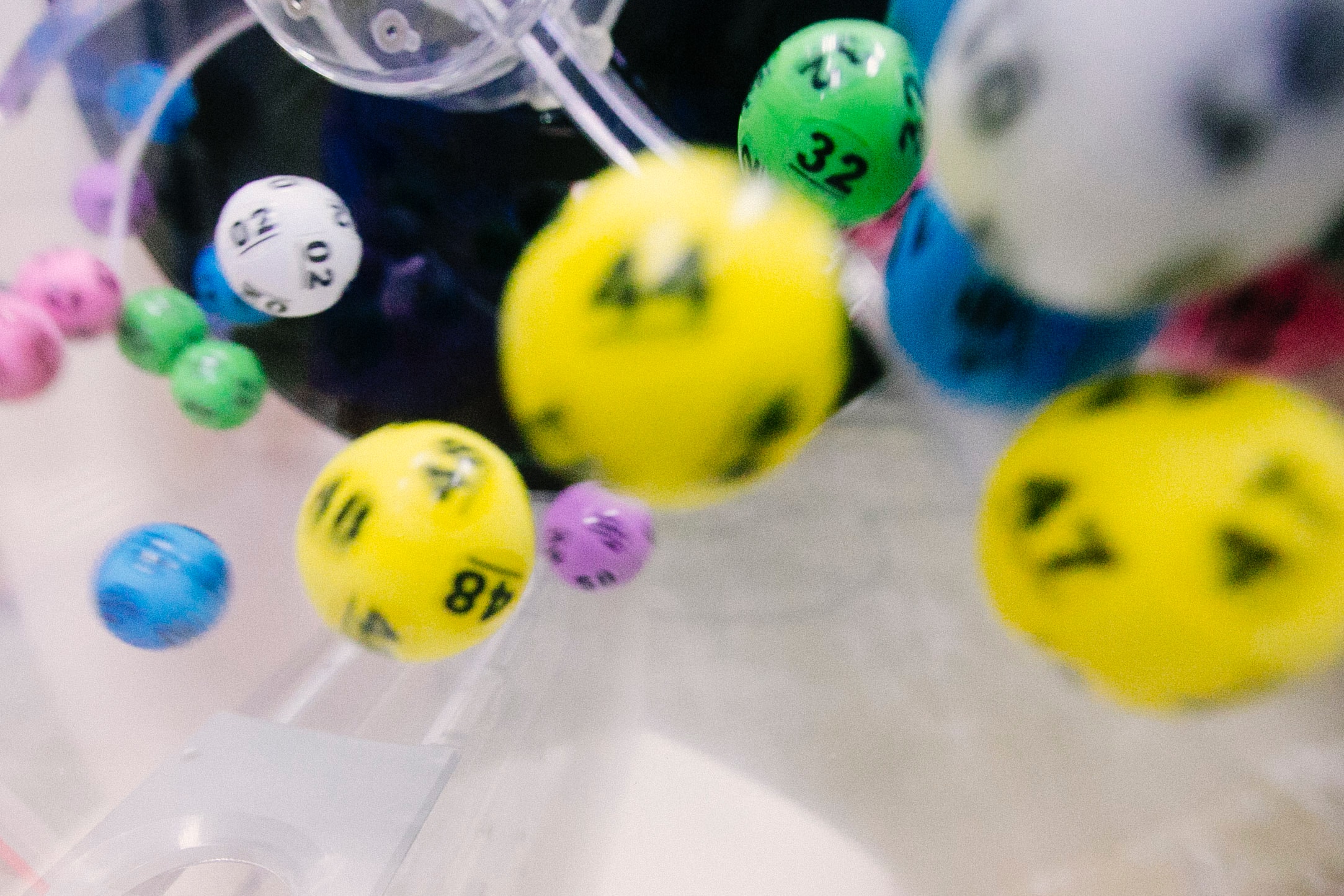 Numbered balls bouncing around inside a lottery machine, the mechanism used in the 2024 WNBA draft lottery
