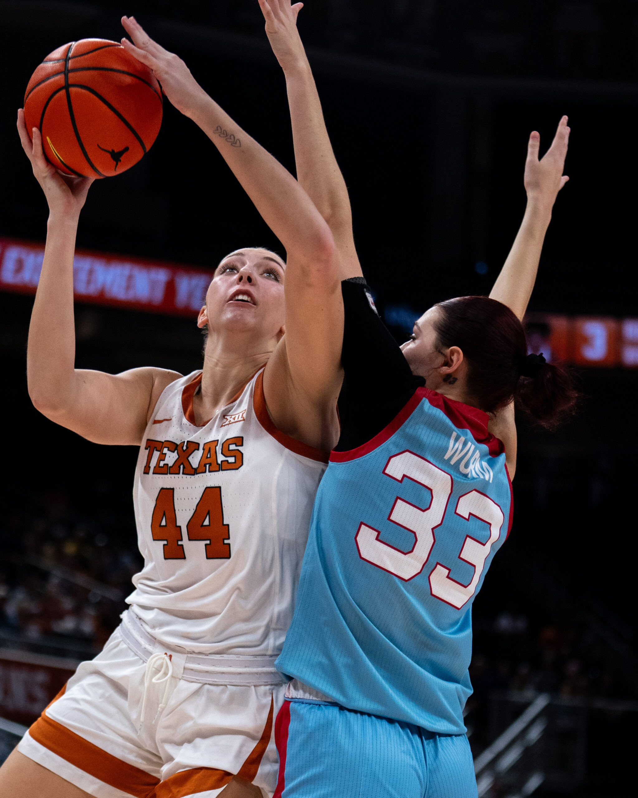 Texas forward Taylor Jones goes up for a layup against a defender.