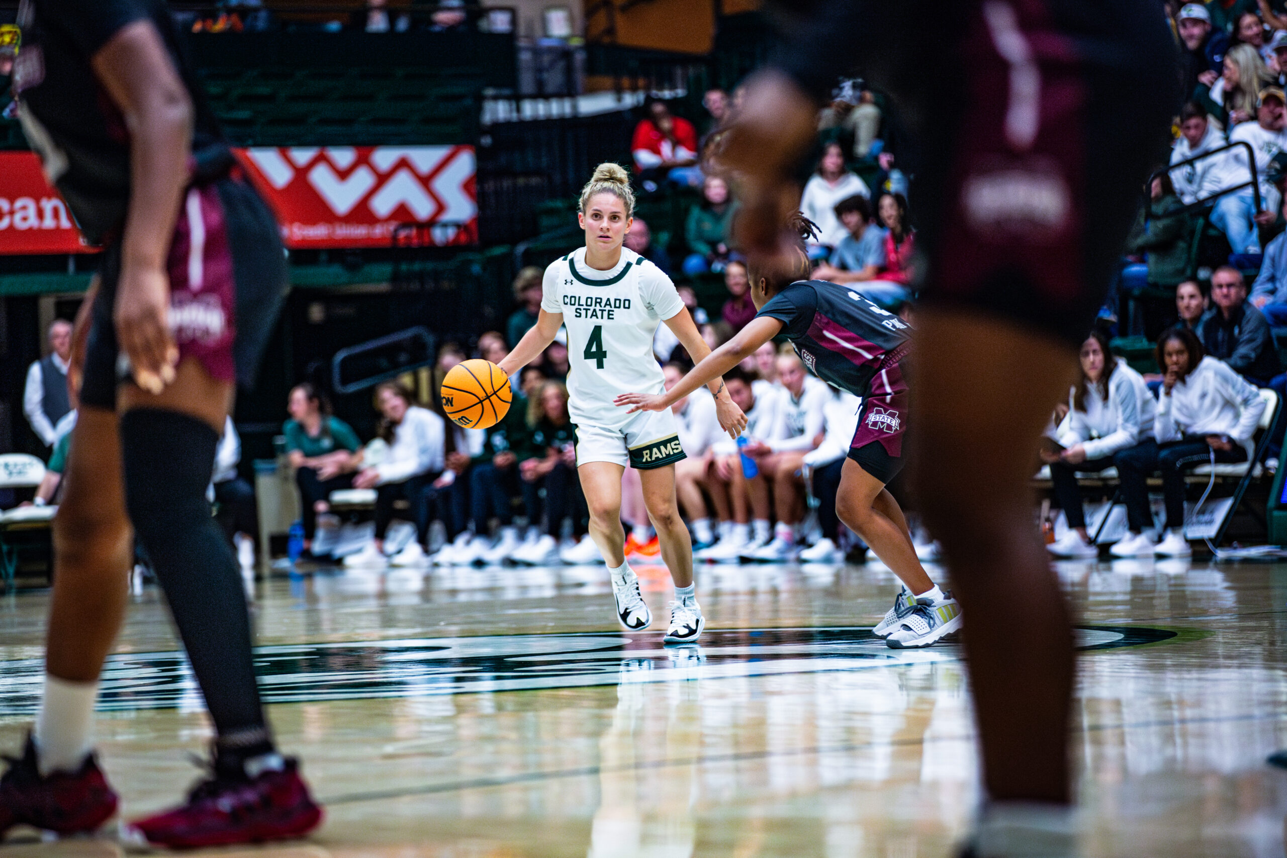 Colorado State guard McKenna Hofschild dribbles the ball near center court with her right hand.
