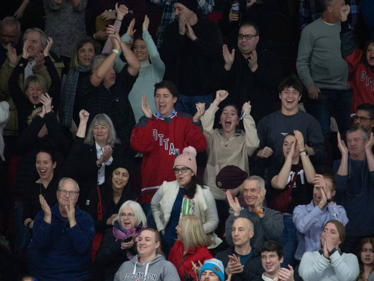 Justin, Ella Grace, and Xavier Trudeau cheer for a PWHL Ottawa goal