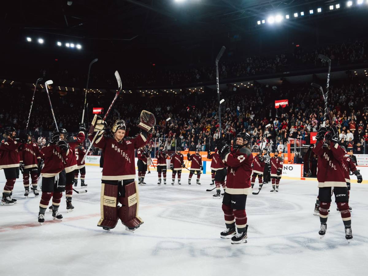 At center ice, Montréal celebrates their win over Ottawa with the home crowd in their maroon home uniforms.