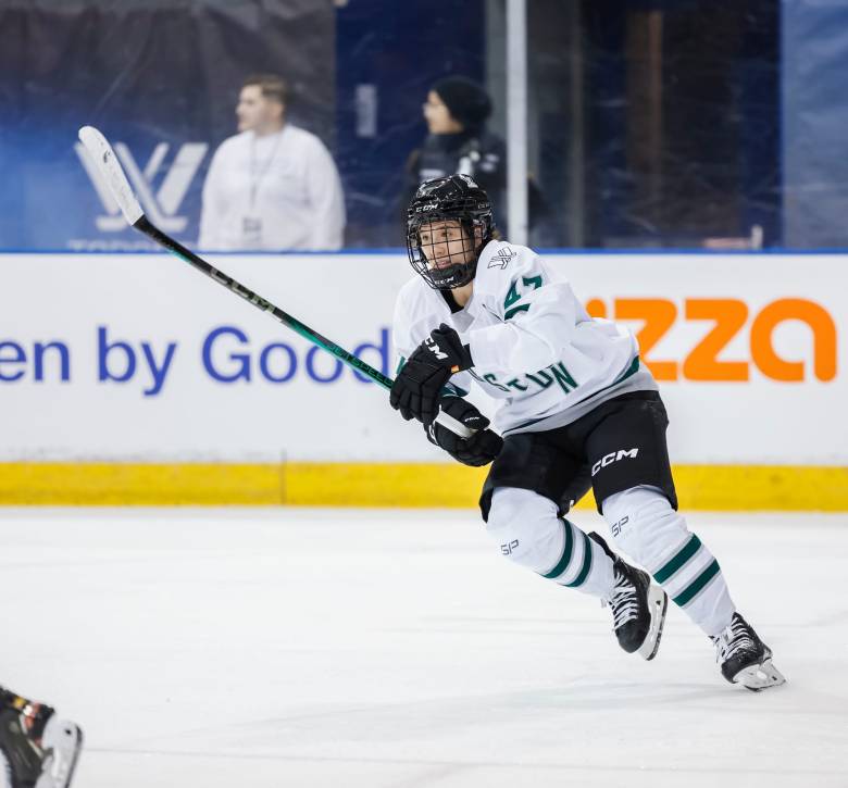 Jamie Lee Rattray, wearing her white away uniform, hunts the puck during a previous game.