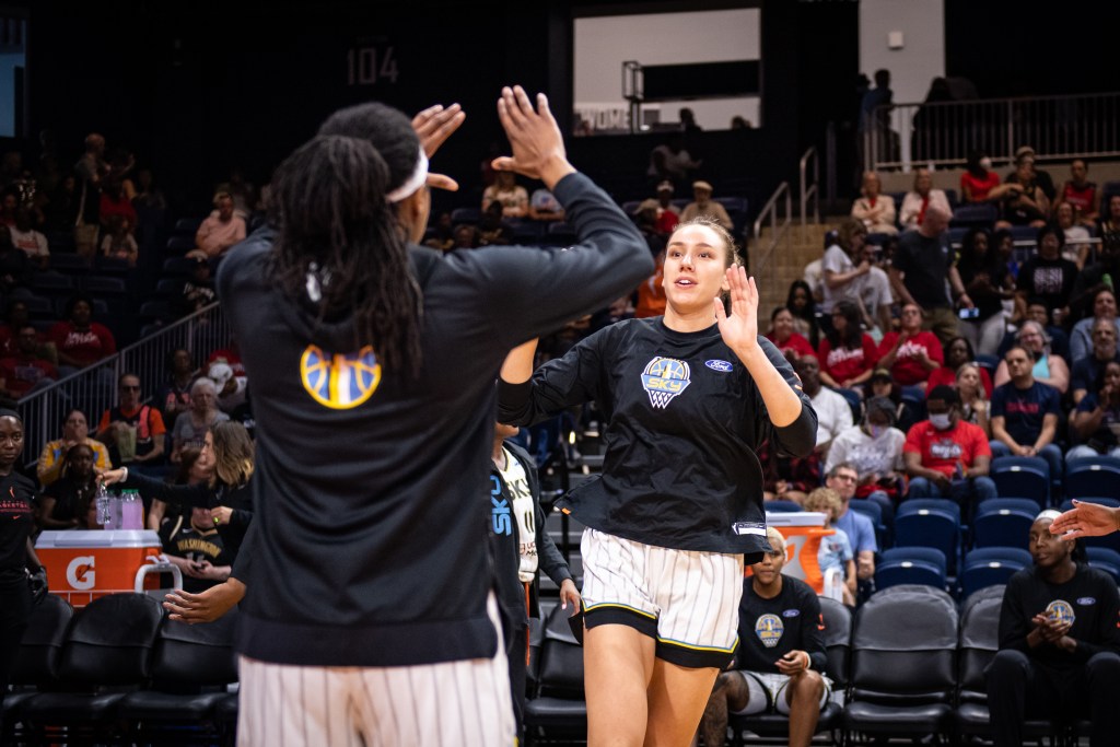 Alanna Smith high fives her teammate during introductions for a game