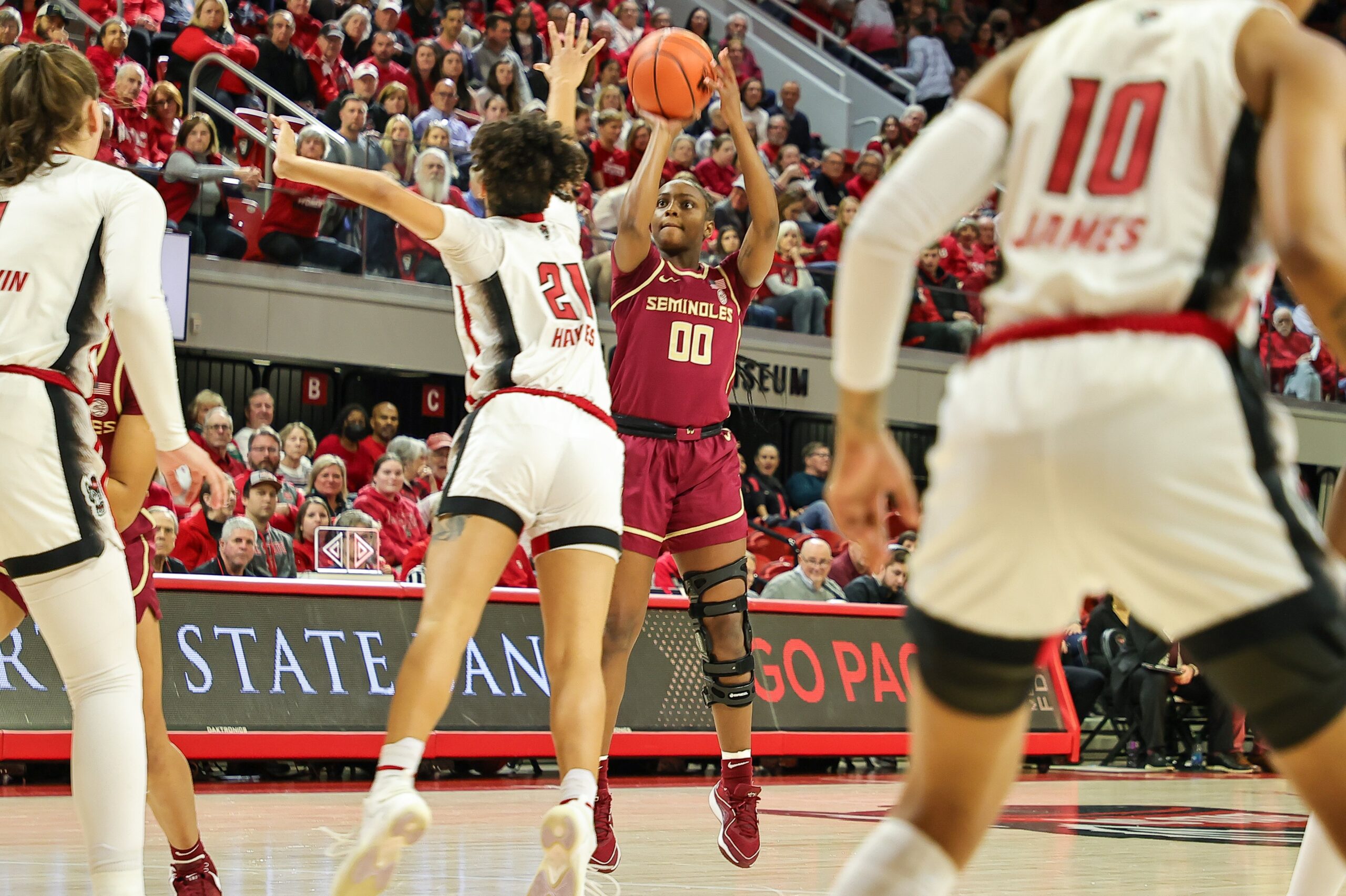 Florida State guard Ta'Niya Latson (00) shoots over a defender during a game against NC State
