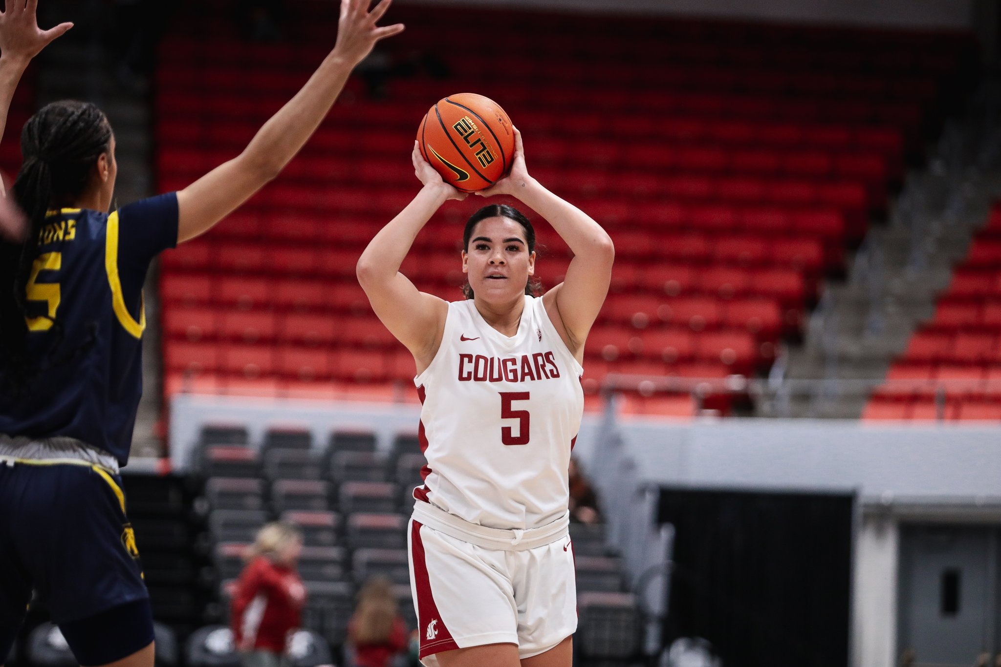 Washington State point guard Charlisse Leger-Walker looks to throw an overhead pass in a home win over UC Davis on Dec. 1, 2023.