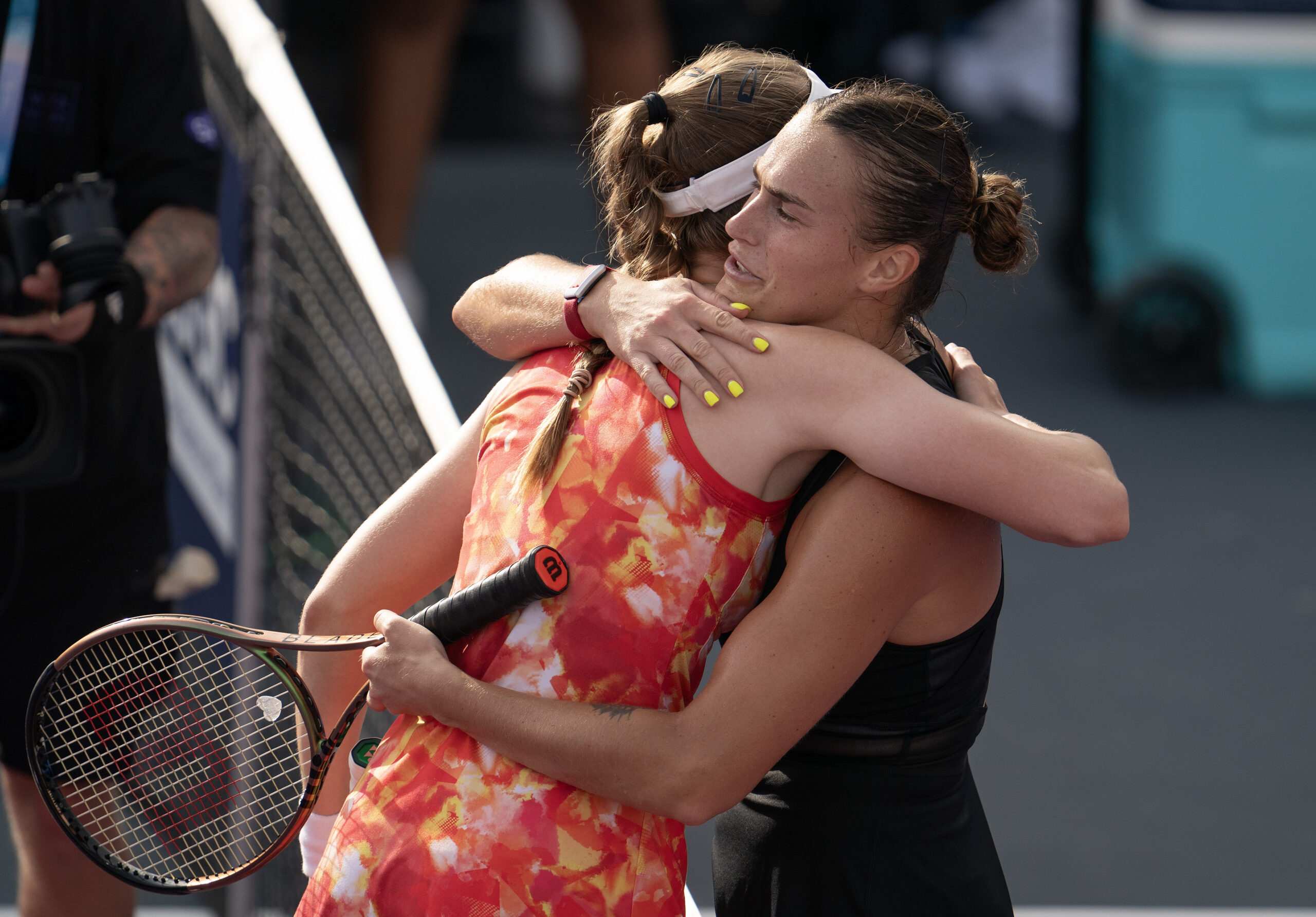 Elena Rybakina and Aryna Sabalenka hugging after playing a tennis match