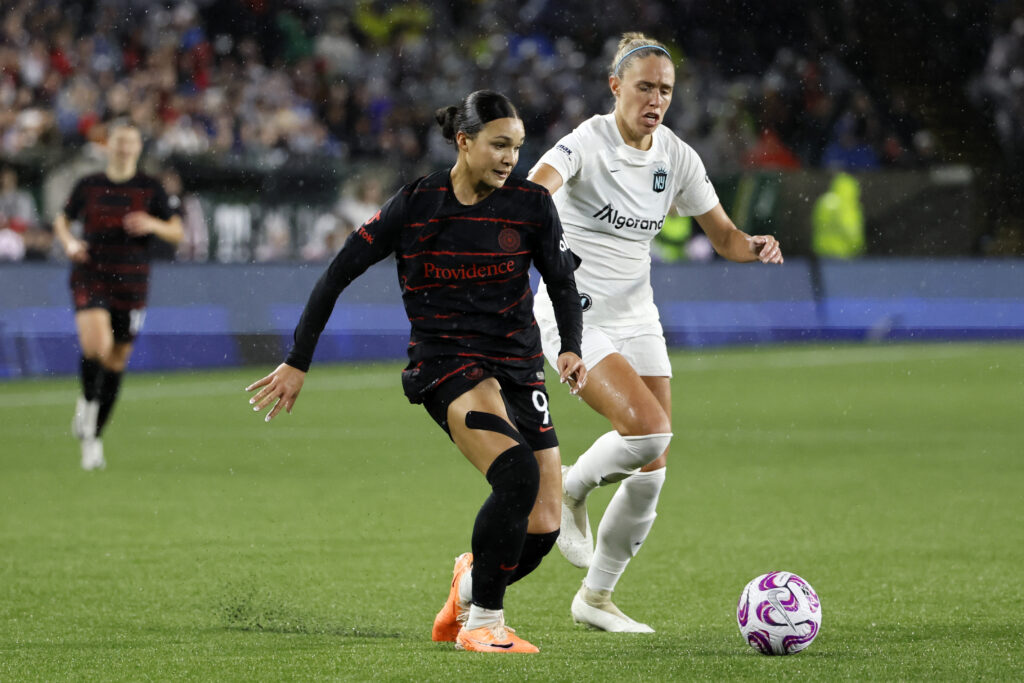 Nov 5, 2023; Portland, Oregon, USA; Portland Thorns FC forward Sophia Smith (9) controls the ball as New Jersey/New York Gotham FC midfielder Maitane Lopez (77) defends during the second half at Providence Park. Mandatory Credit: Soobum Im-USA TODAY Sports