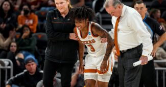 Texas Longhorns guard, Rori Harmon (3) helped off the court after a leg injury in the fourth quarter of the women’s NCAA playoff game against Louisville at the Moody Center on Monday Mar. 20, 2023 in Austin.